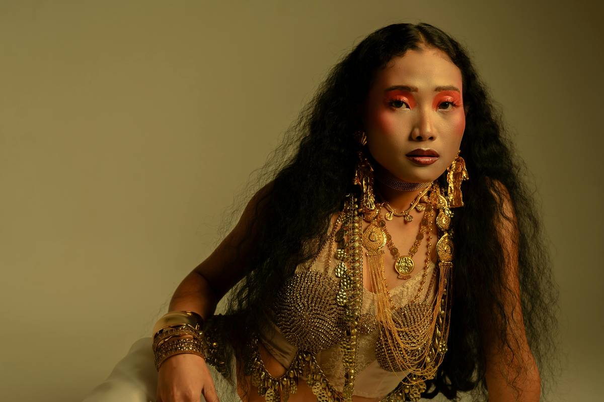 Model wearing avant-garde makeup with geometric metallic shapes representing Unique Concepts in editorial beauty photography.