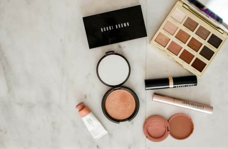 Professional makeup artist applying editorial eye makeup with brushes and pigment palette